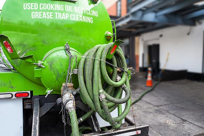 a technician pumping a grease trap in a commercial building in Maybrook